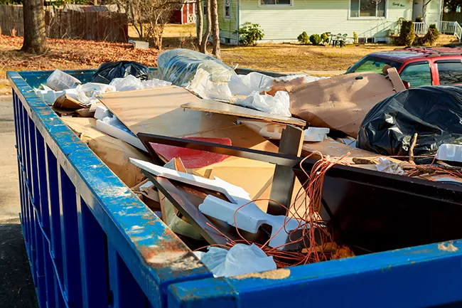 dumpster full of junk being removed